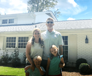 Eco Three client Patrick Thompson and his family standing in front of their two-story home.